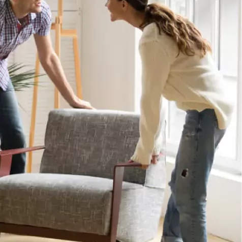 Carpet-Installation-process Couple Moving sofa | Titan Flooring